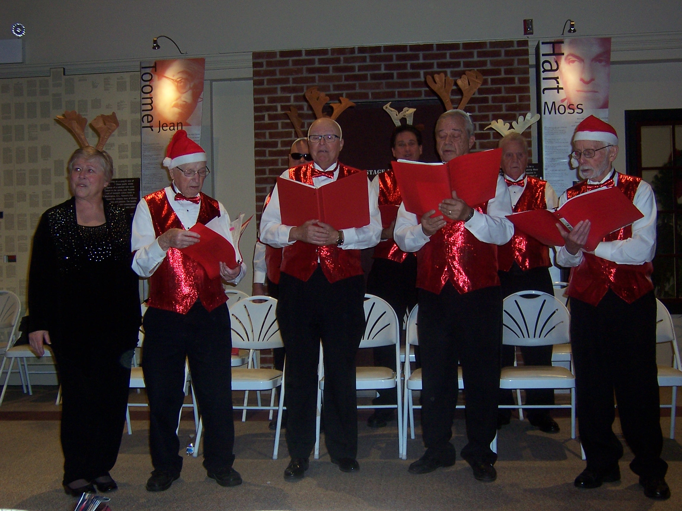 The chorus singing, onstage, in festive attire (4 of 4)