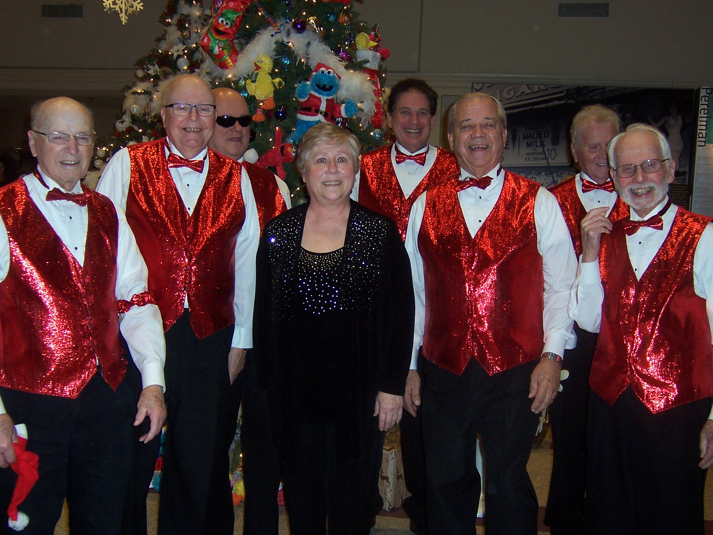 Group photo of the chorus, onstage, in festive attire (1 of 2)